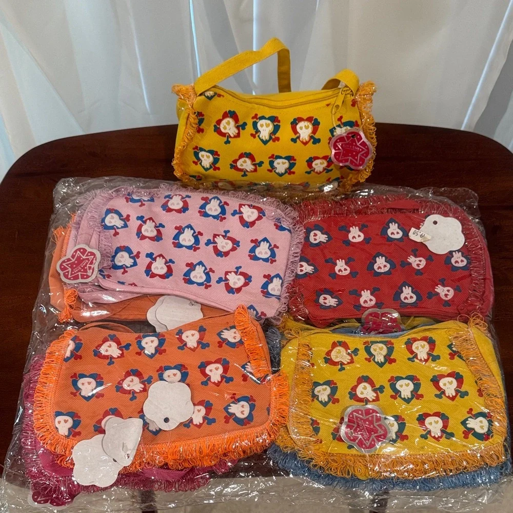 New One Dozen Charming kids' bags with playful hearted skulls.